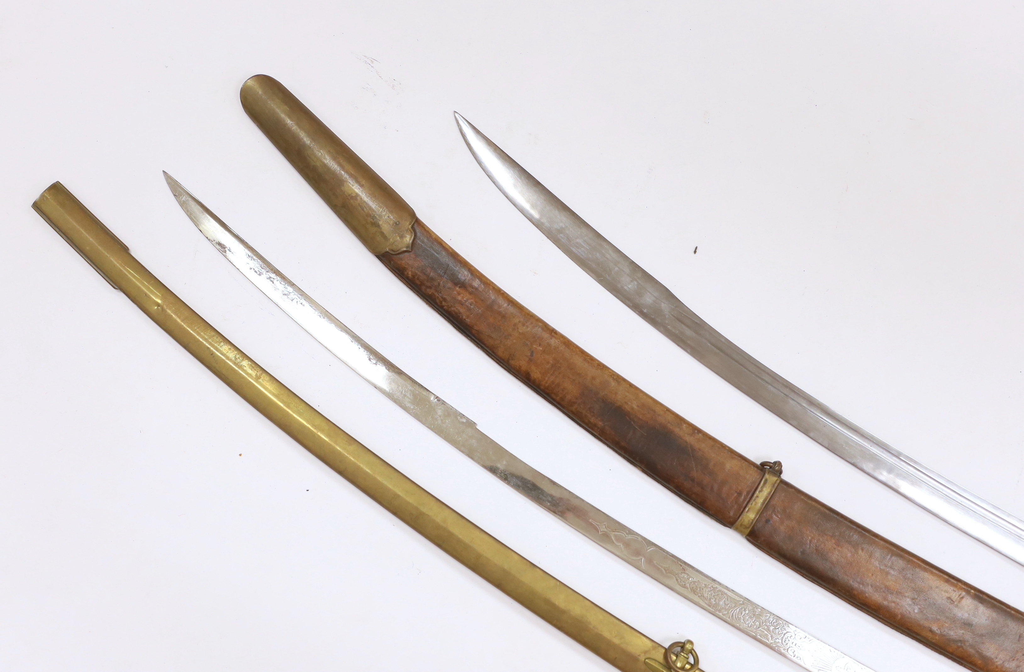 Two reproduction swords; a Victorian style naval design Mameluke sword, together with an Indian style sword, longest blade 84cm